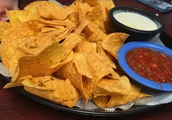 Chips with cheese dip and salsa