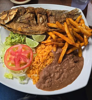 Fried tilapia with rice, beans, fries and salad